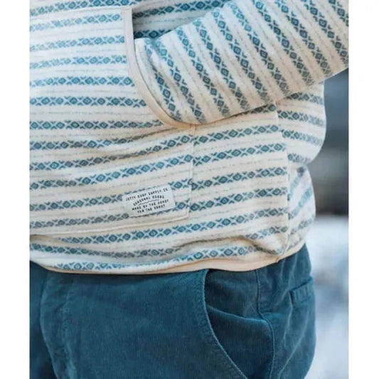 A close-up of the Jetty Men's Quintin Fleece Hoodie in Grey, showing the front pocket and patterned design against a blurred background.