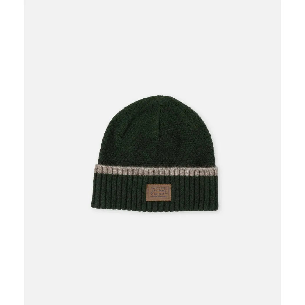Olive Jetty Southport Beanie with a ribbed cuff and leather patch, photographed from above on a white background.