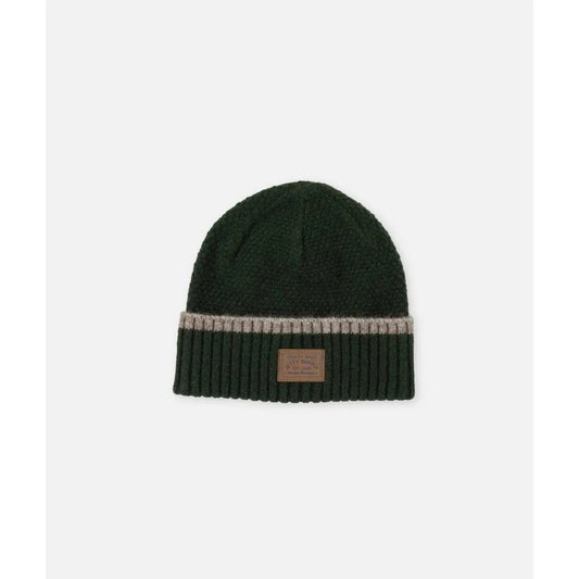 Olive Jetty Southport Beanie with a ribbed cuff and leather patch, photographed from above on a white background.