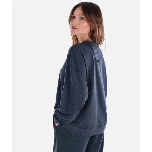 Side view of the Jetty Women's Rosewood Crewneck Sweatshirt in Navy showing the model wearing it against a plain white background.