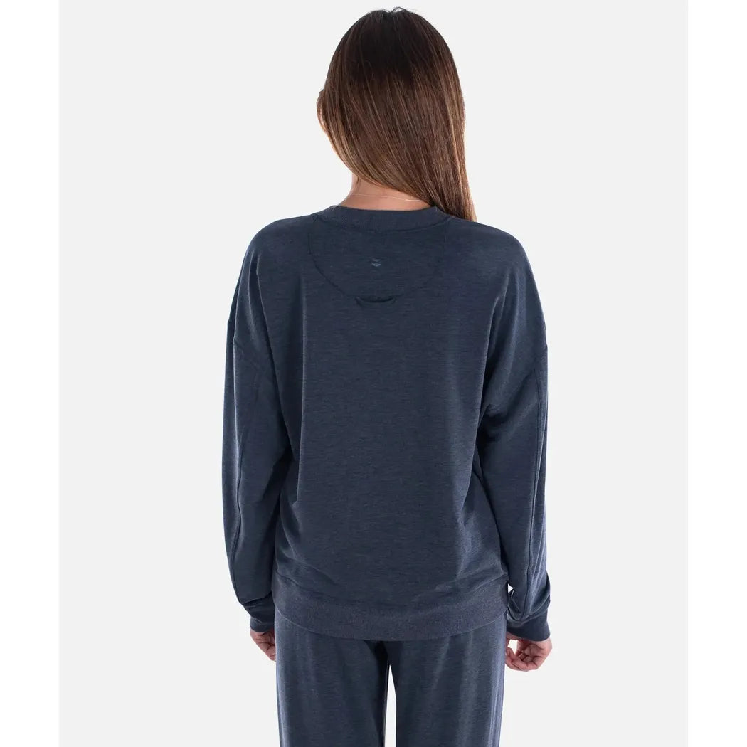 Back view of the Jetty Women's Rosewood Crewneck Sweatshirt in Navy on a model against a plain white background.