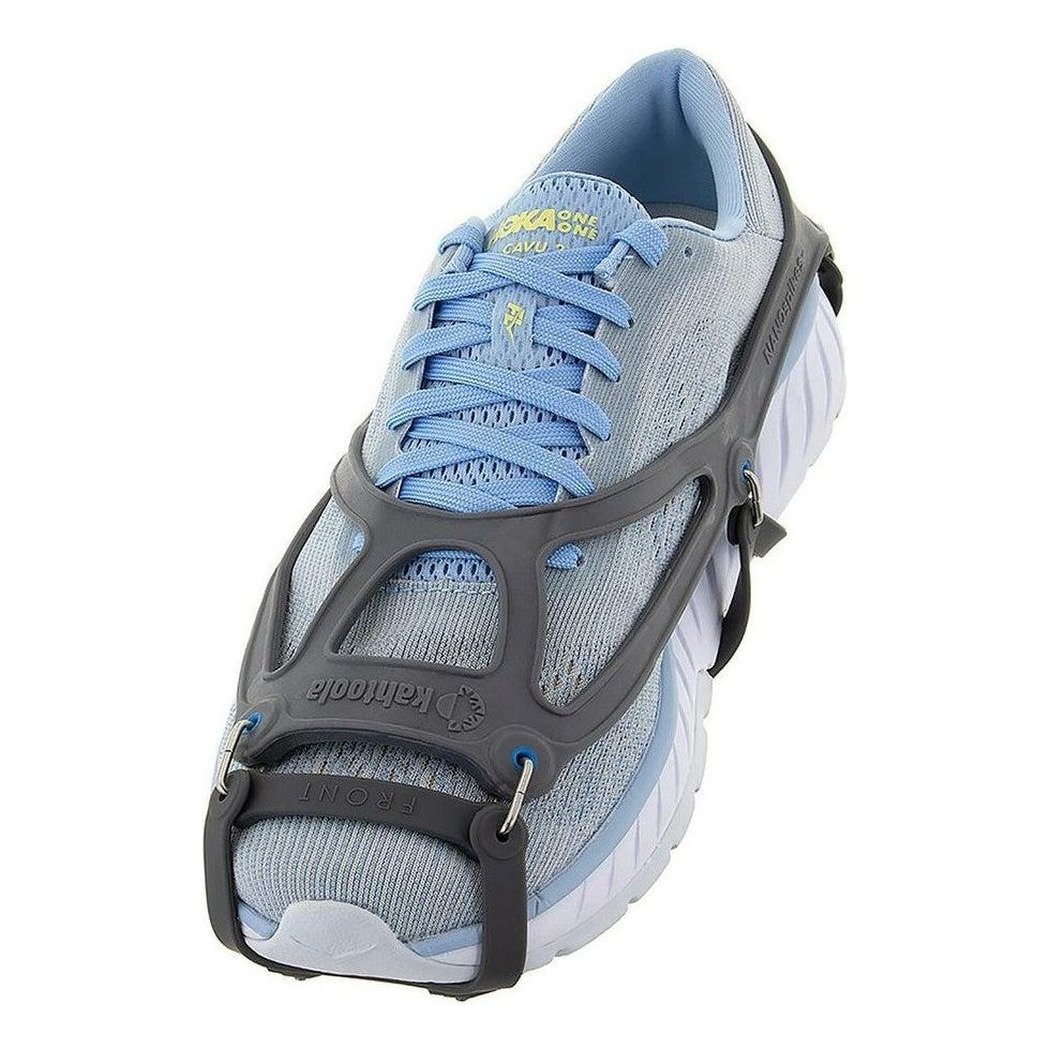 A side view of the Kahtoola NANOspikes Footwear Traction on a light blue running shoe with a black traction device, against a white background.
