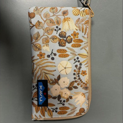 A top-down view of the Kavu Clutch Case in Frosty Foliage with a blue Kavu tag and a black and white tag attached.
