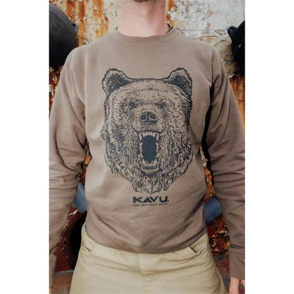 A front view of the Kavu Men's Core Crew Brown Bear sweatshirt on a model with a rusted metal background.