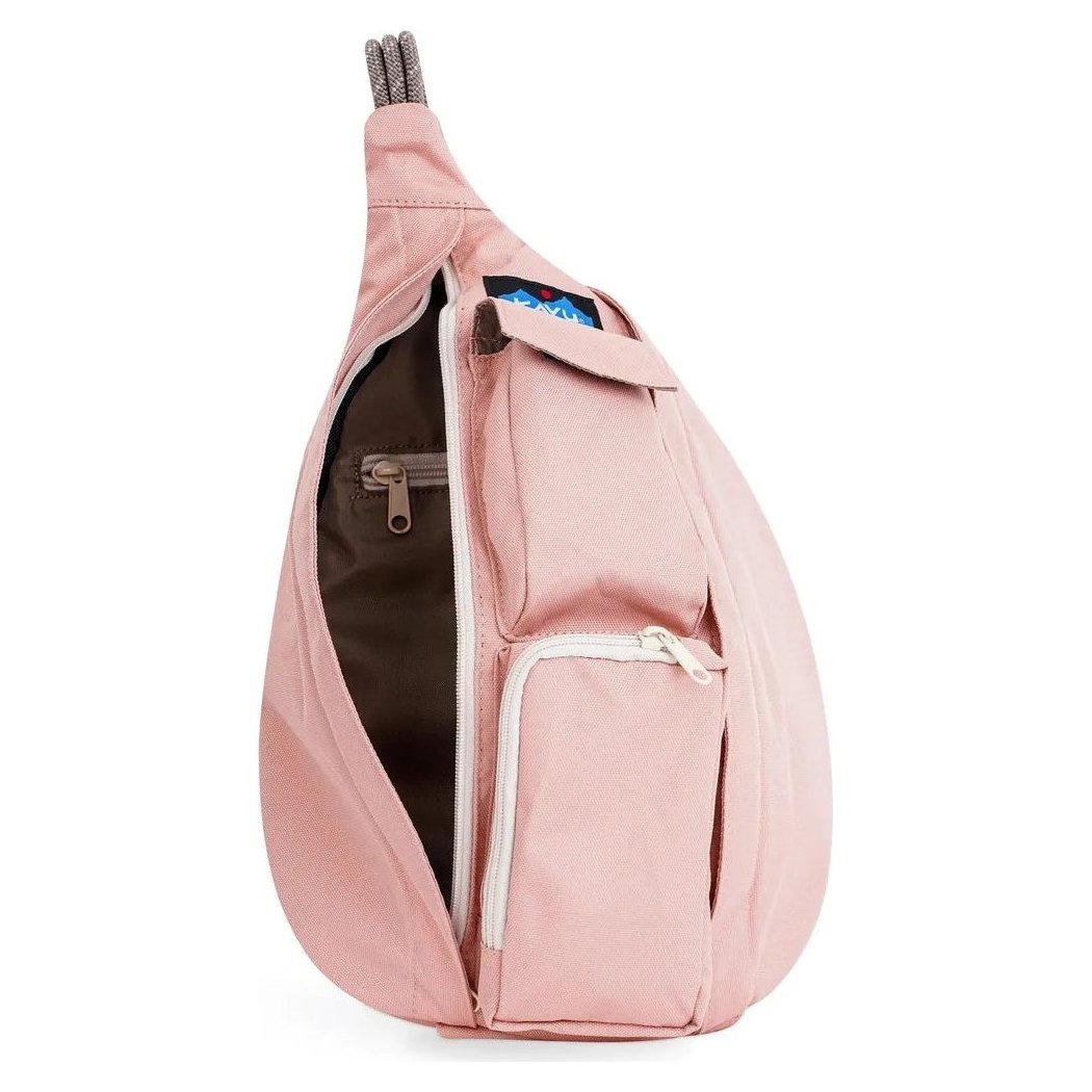 Side view of the Kavu Mini Rope Sling in Pink showing the front pocket and open main compartment against a white background.