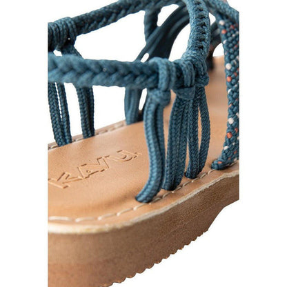 A close-up of the Kavu Women's Alderbrooke sandals in Pavement color, showing the braided straps and tan sole with the brand name embossed.