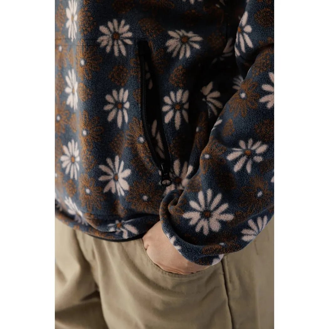 A close-up of the Kavu Women's Cavanaugh Fall Floral fleece top, showing the front pocket and model wearing it.