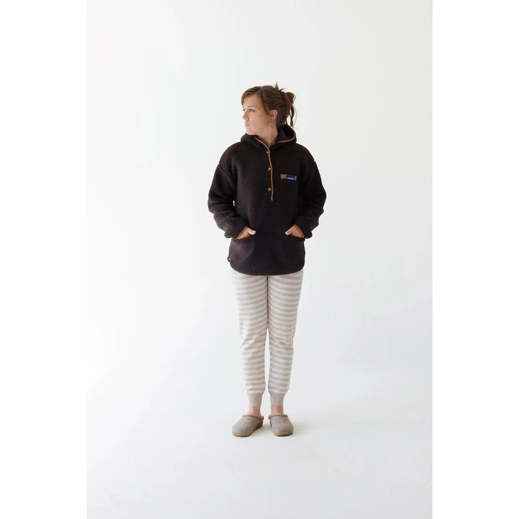 A woman wearing the Kavu Women's Roselake Coffee top stands against a white background.