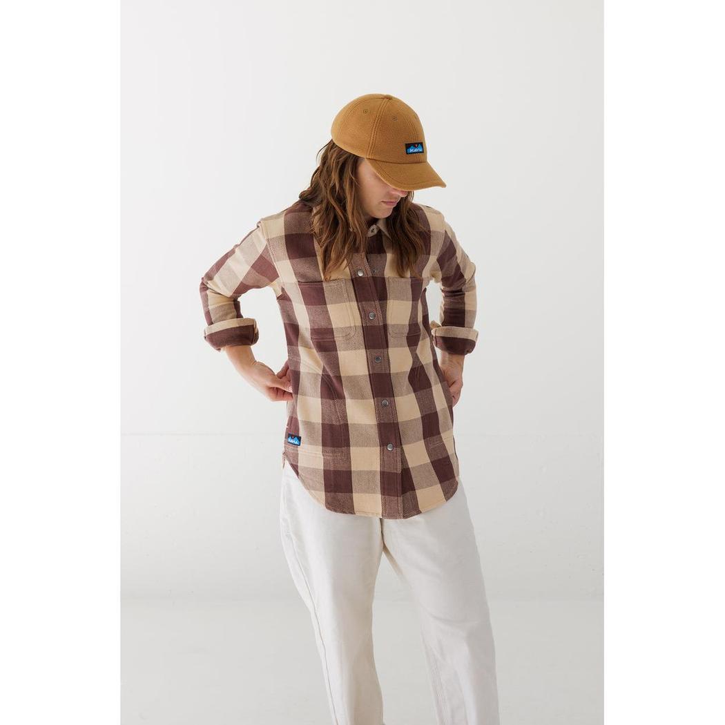 A woman wearing the Kavu Women's Wren in Plateau Trail stands with her hands on her hips against a plain white background.