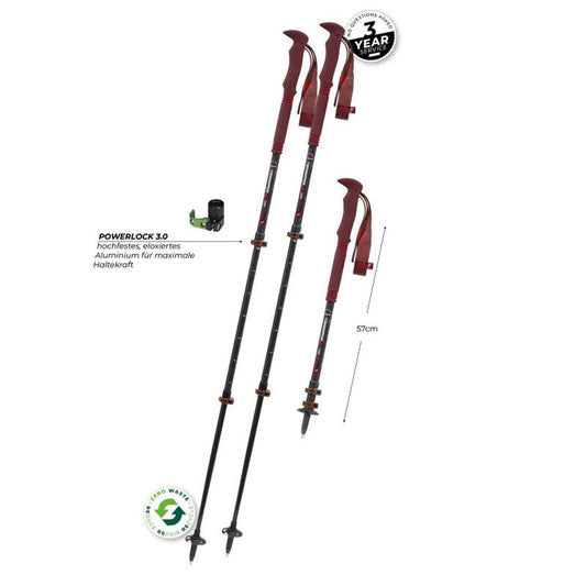 Two Komperdell Carbon PRO ZERO Compact trekking poles in charcoal/graphite with red handles, showing Powerlock 1.0 mechanism and 57cm length against a white background.