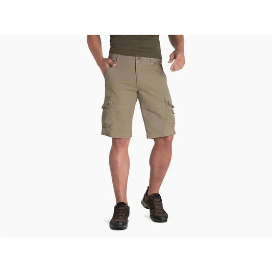 Side view of the Kuhl Men's Ambush Cargo shorts on a model wearing dark shoes against a white background.