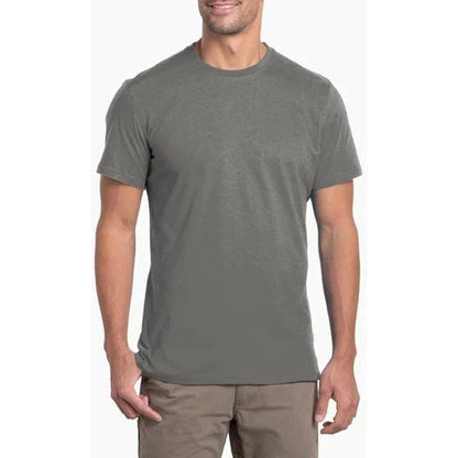 A front view of the Kuhl Men's Bravado in Carbon on a model wearing khaki pants against a white background.