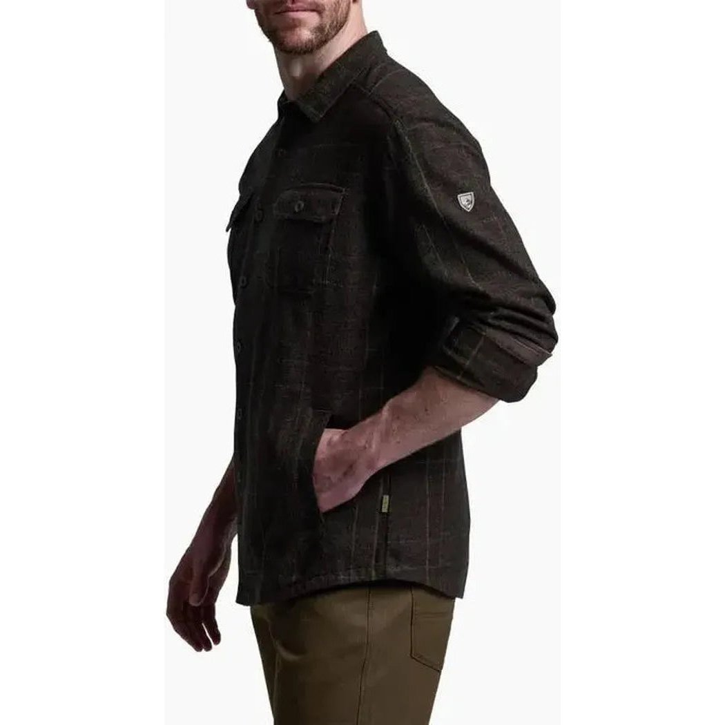 Side view of the Kuhl Men's Deviatr Shirt-Jac in Dark Roast showing the chest pocket and rolled sleeves against a white background.