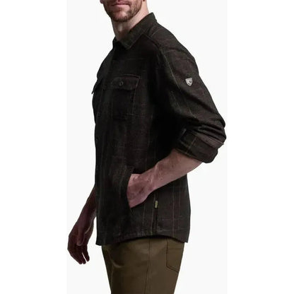 Side view of the Kuhl Men's Deviatr Shirt-Jac in Dark Roast showing the chest pocket and rolled sleeves against a white background.