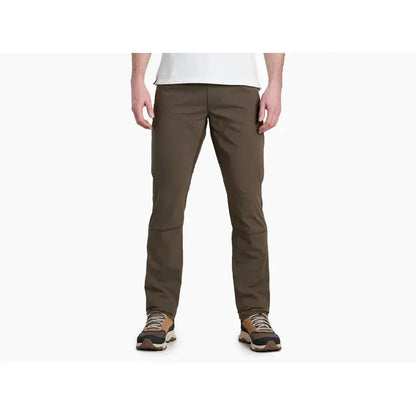 A front view of the Kuhl Men's Free Radikl in Vintage Green on a model wearing brown hiking shoes against a white background.