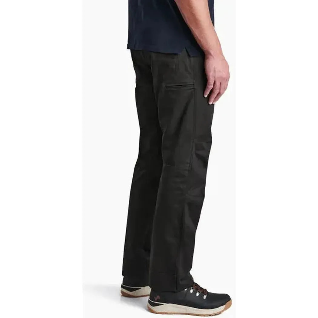 Side view of the Kuhl Men's Free Rydr in Espresso showing the straight leg fit and model wearing them against a white background.