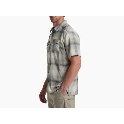 Side view of the Kuhl Men's Konquer Short Sleeve in Feather Grey showing the chest pocket and model wearing it against a white background.