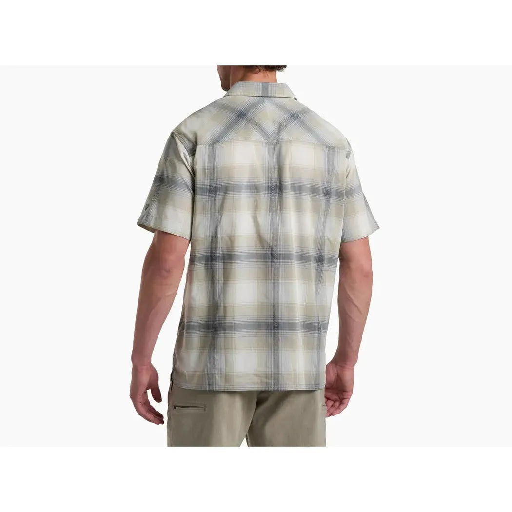 Back view of the Kuhl Men's Konquer Short Sleeve in Feather Grey on a model wearing khaki pants against a white background.
