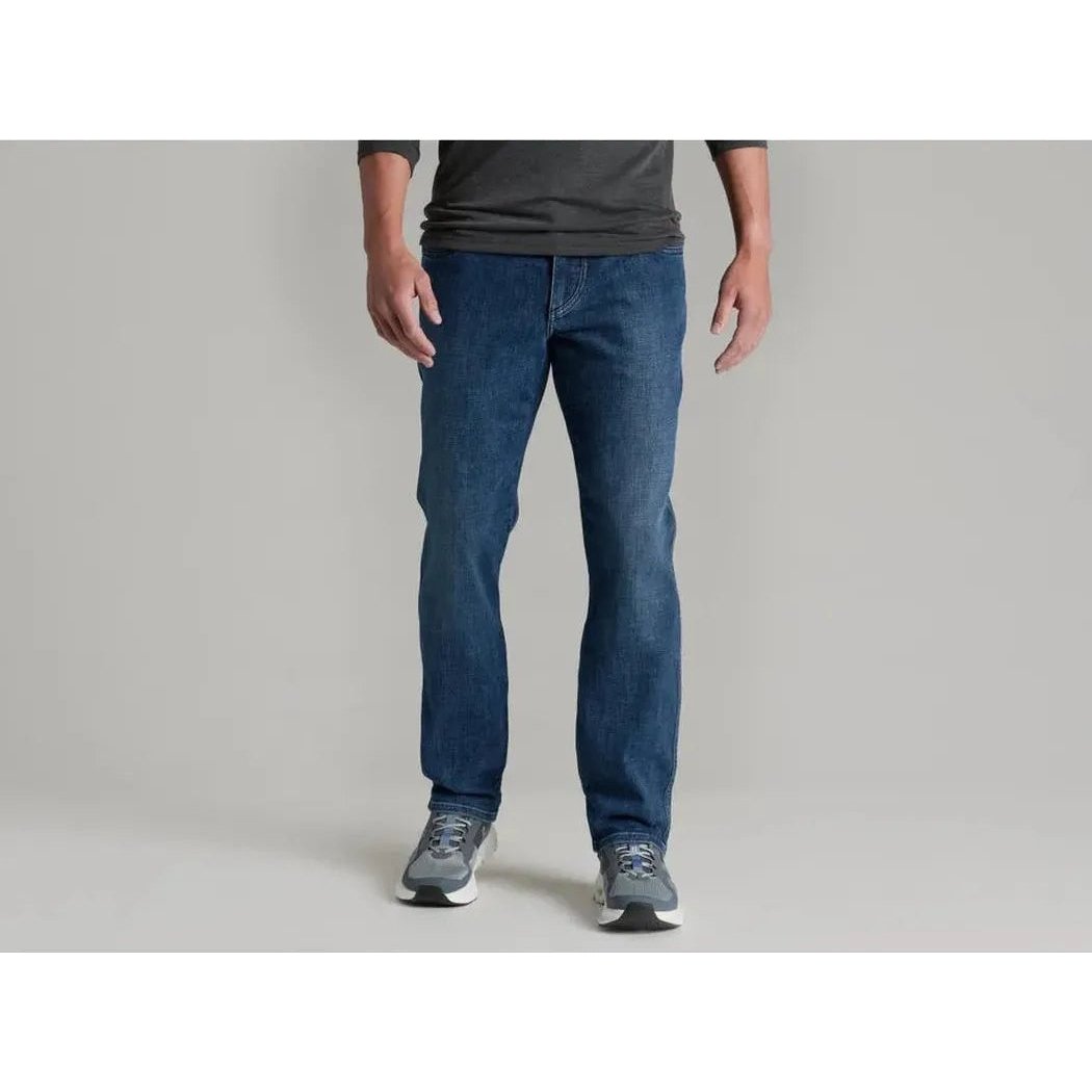 A front view of the Kuhl Men's Kontrol Denim Klassik in Medium Wash on a model wearing gray sneakers against a plain background.