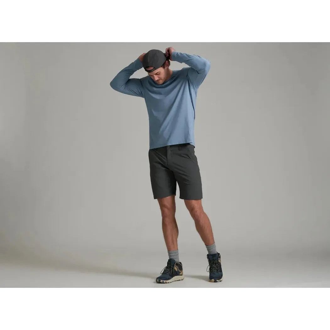 A model wearing the Kuhl Men's Kovert Hoody in Mineral Blue poses against a plain gray background.