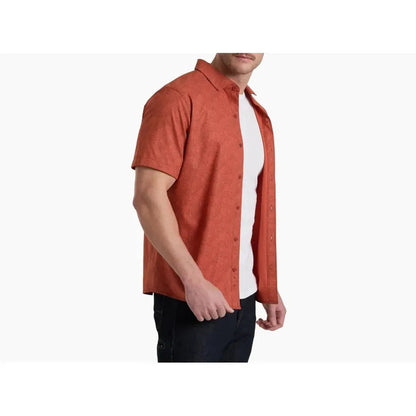 Side view of the Kuhl Men's KUHL Breeze Short Sleeve in Glacier showing the short sleeves and white undershirt against a plain white background.