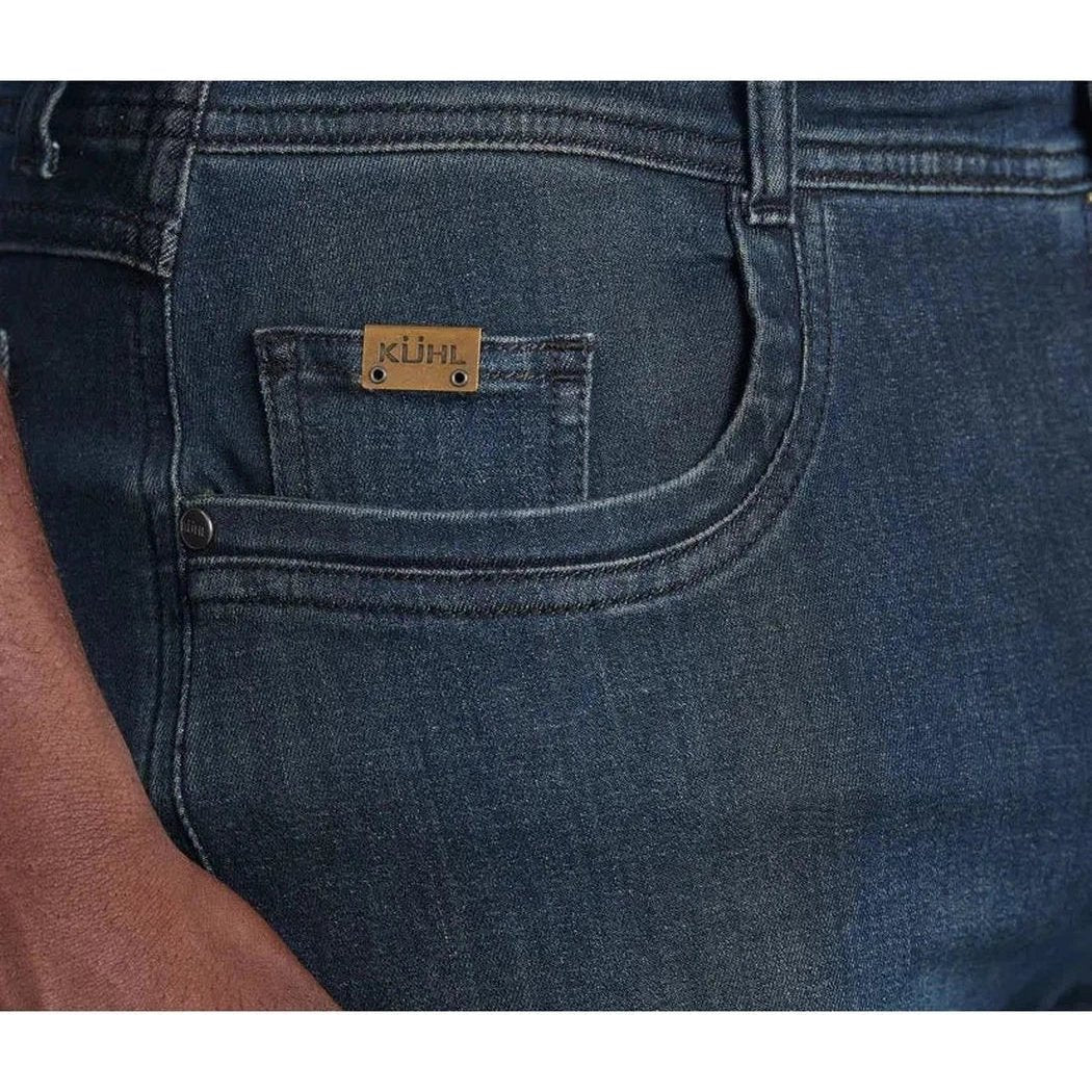 Midnight blue Kuhl Men's Kuhl Denim jeans close up showing the back pocket and brand tag.
