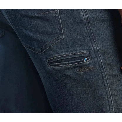 Side view of the Kuhl Men's Kuhl Denim in Midnight showing the zippered pocket and brand name on the denim.