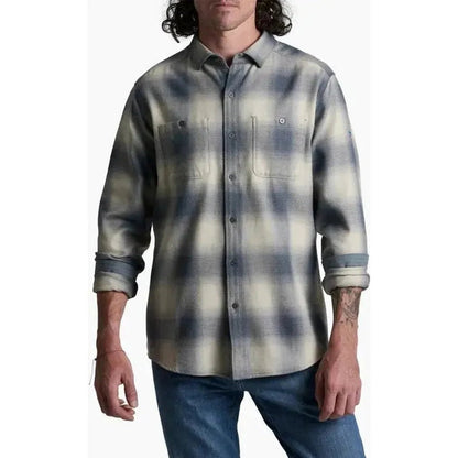 A front view of the Kuhl Men's Law Flannel Long Sleeve in Fog Harbor shows the model wearing it with blue jeans against a white background.