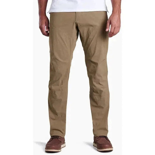 Front view of the Kuhl Men's Renegade Pant in Buckskin Khaki on a model wearing brown shoes against a white background.