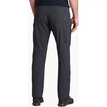 Back view of the Kuhl Men's Renegade Pant in Buckskin Khaki on a model against a white background.