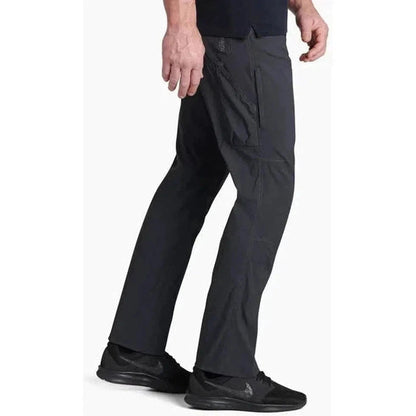 Side view of the Kuhl Men's Renegade Pant in Buckskin Khaki showing the cargo pocket and model wearing it against a white background.