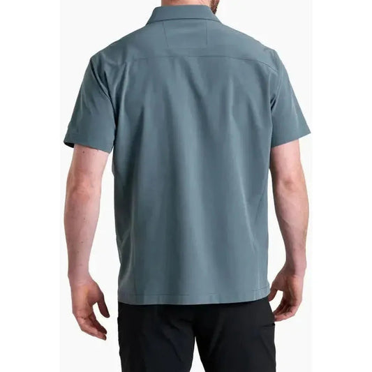 Back view of the Kuhl Men's Renegade Shirt in Charcoal Blue on a model wearing black pants against a white background.