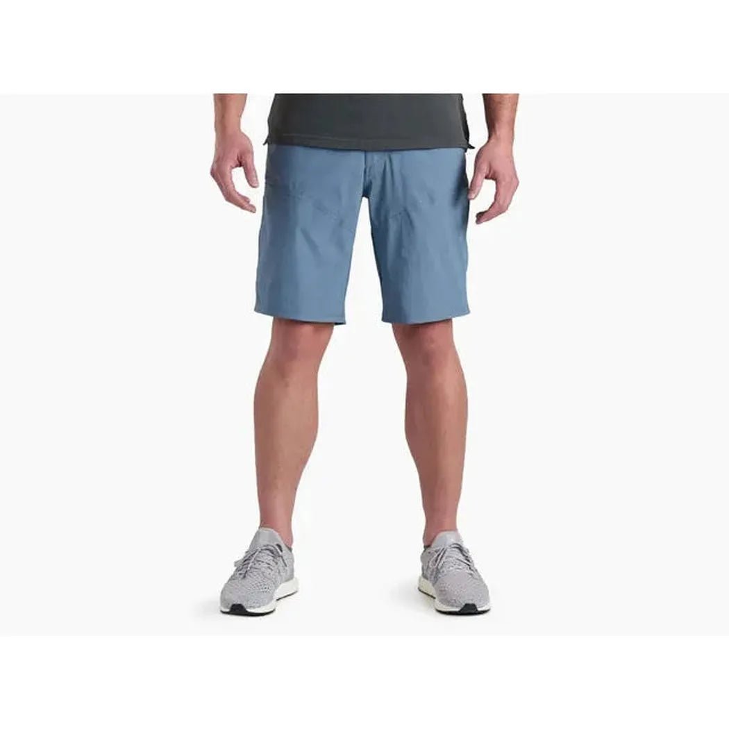 A front view of the Kuhl Men's Renegade™ Short in Charcoal Blue on a model wearing gray sneakers against a white background.