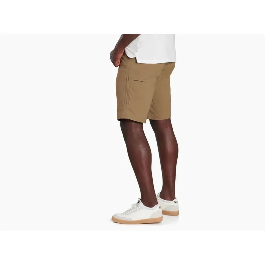 Side view of the Kuhl Men's Renegade™ Short in Charcoal Blue on a model wearing white sneakers against a plain white background.