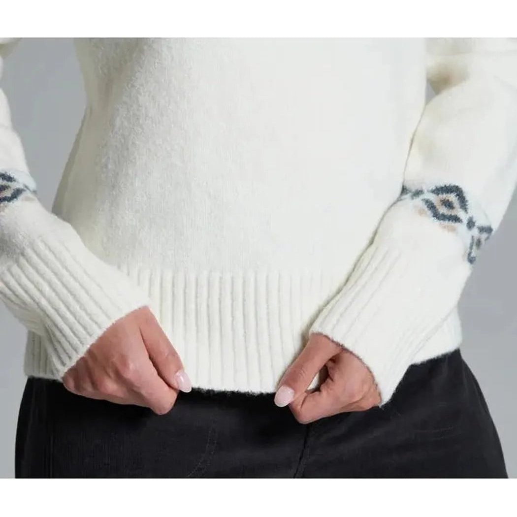 A close-up of the Kuhl Women's Alpina Sweater in Alpine White, showing the ribbed cuffs and hem, worn by a model against a plain background.