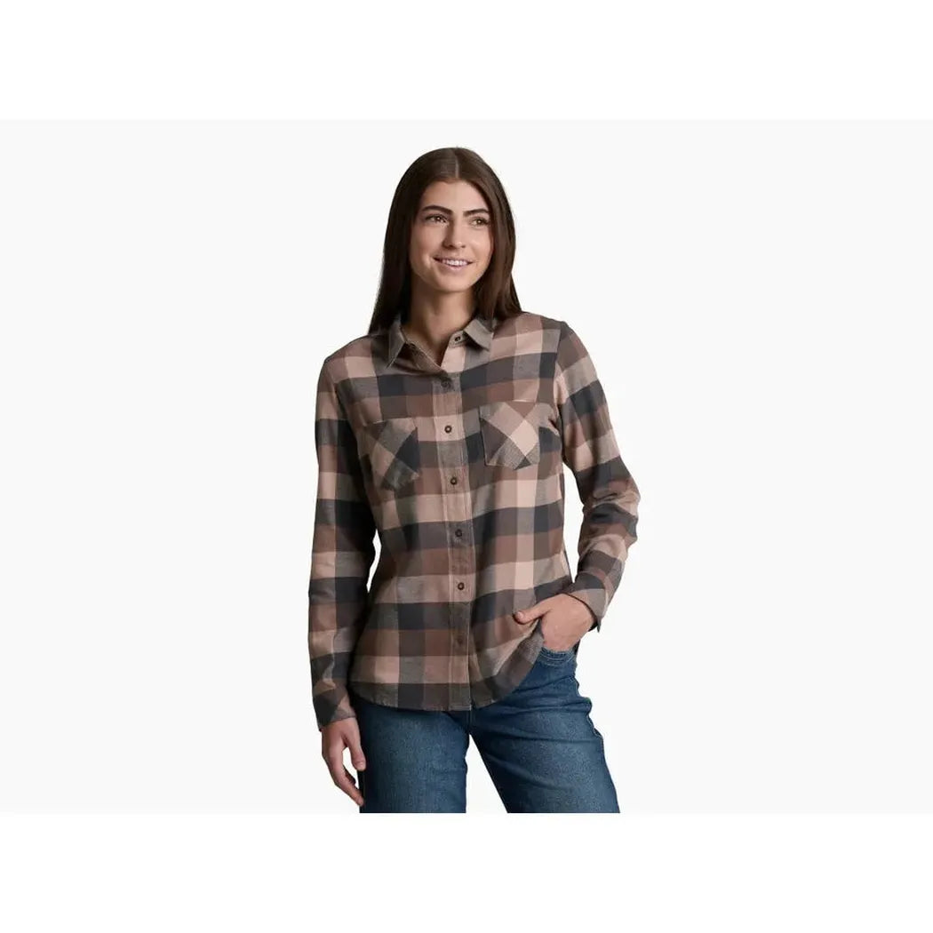 A woman wearing the Kuhl Women's Darcy Flannel in Cherrywood stands against a plain white background.