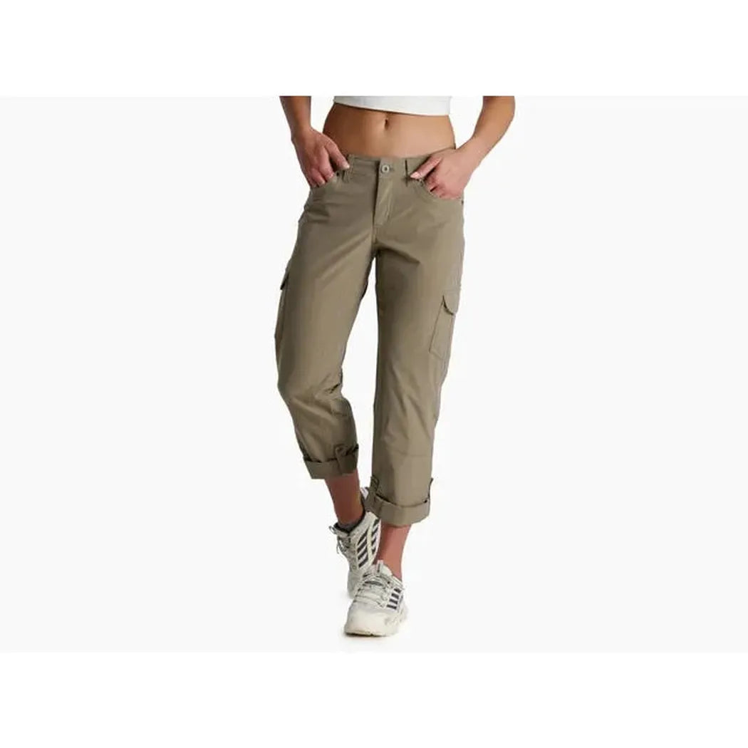 A front view of the Kuhl Women's Freeflex Roll-Up Pant in Fallow, showing the cargo pocket and rolled cuffs on a model wearing white sneakers against a white background.