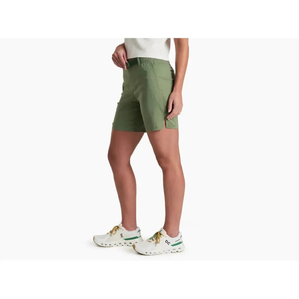 Side view of the Kuhl Women's Haven Short 7' in Slate Green on a model wearing white sneakers against a white background.