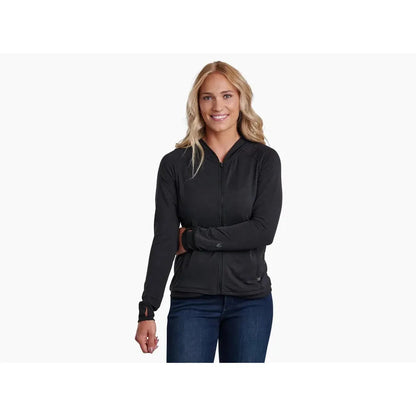 A woman wearing the Kuhl Women's Inspira FZ Hoody in Alpine Lake stands against a plain white background.