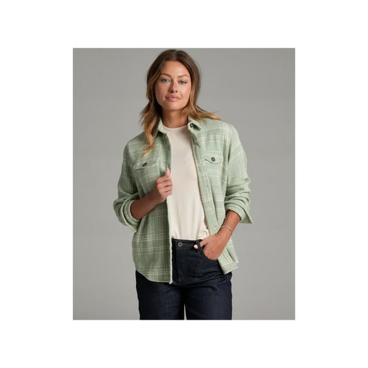 A front view of the Kuhl Women's Kove ShirtJak in Sea Crest shows the model wearing it with a white tee and dark jeans against a gray background.