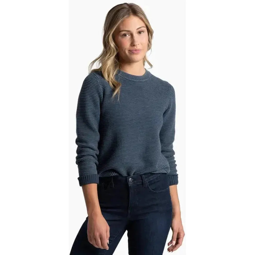 A front view of the Kuhl Women's Sofie Sweater in Metal Blue on a model wearing dark jeans against a white background.