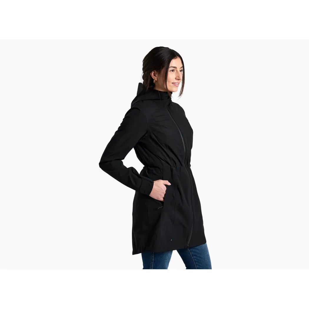 Side view of the Kuhl Women's Stretch Voyagr Trench in Blackout showing the front zipper and pockets against a white background.