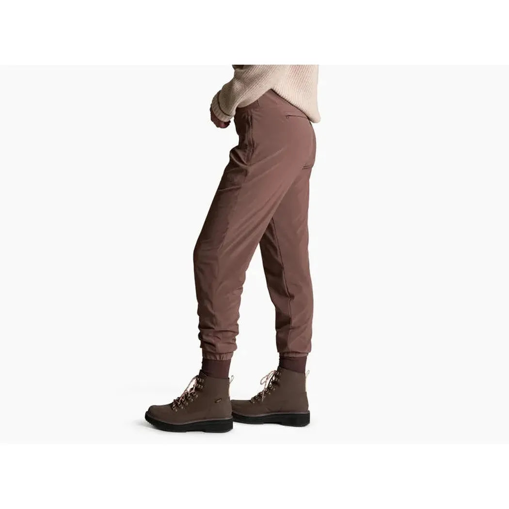 Side view of the Kuhl Women's Vantage Lined Pant in Coffee showing the cuffed hem and model wearing them against a white background.