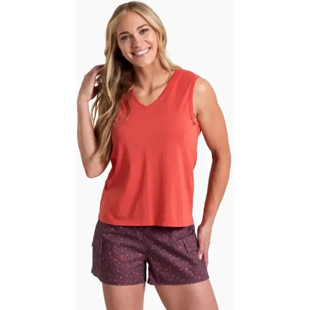 A woman wearing the Kuhl Women's Vega Tank in Sunset color poses against a white background.