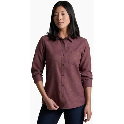 A front view of the Kuhl Women's Whisper Flannel in Raisin showing the button front and pocket on a model against a white background.