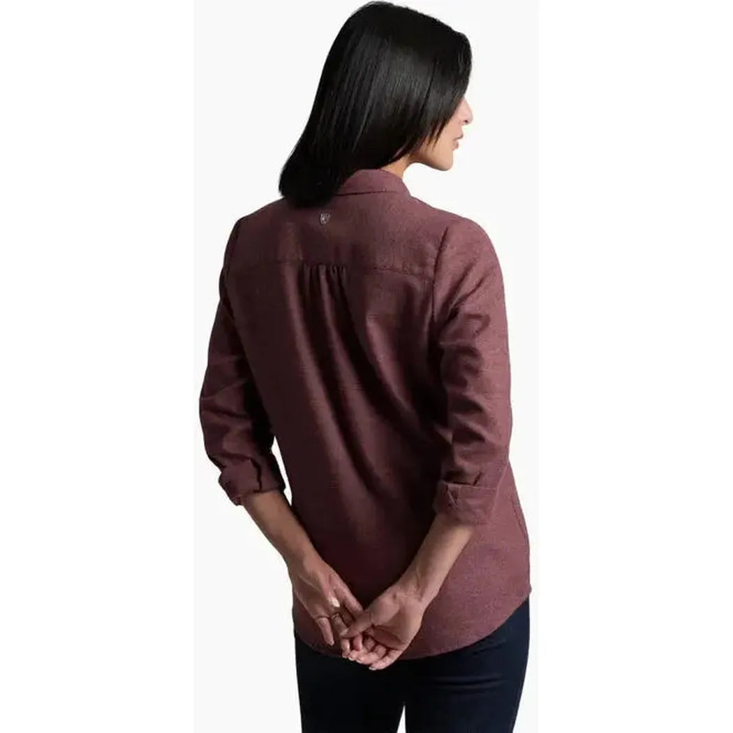 Back view of the Kuhl Women's Whisper Flannel in Raisin showing the model with hands clasped behind her back against a white background.