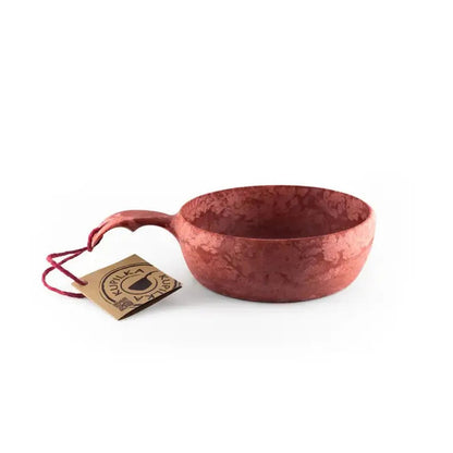 Side view of the Kupilka 55 Soup Bowl in Black showing the handle and a tag against a white background.
