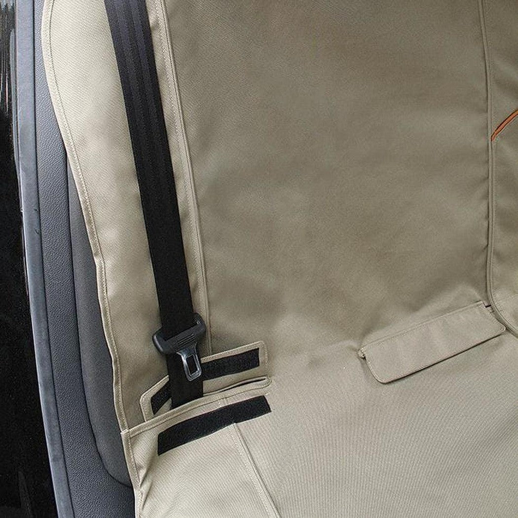 A close-up of the Kurgo Wander Bench Seat Cover in Black, showing the seatbelt attachment and pocket detail.