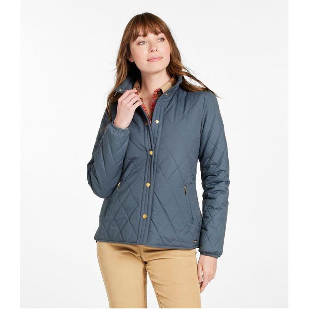 A woman wears the L.L.Bean Display Sample - Women's Bean Cozy Quilted Jacket in Rangeley Blue against a white background.