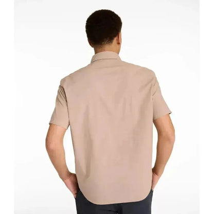 Back view of the L.L.Bean Men's Comfort Stretch Performance Chambray Shirt in Camel Brown on a model against a white background.